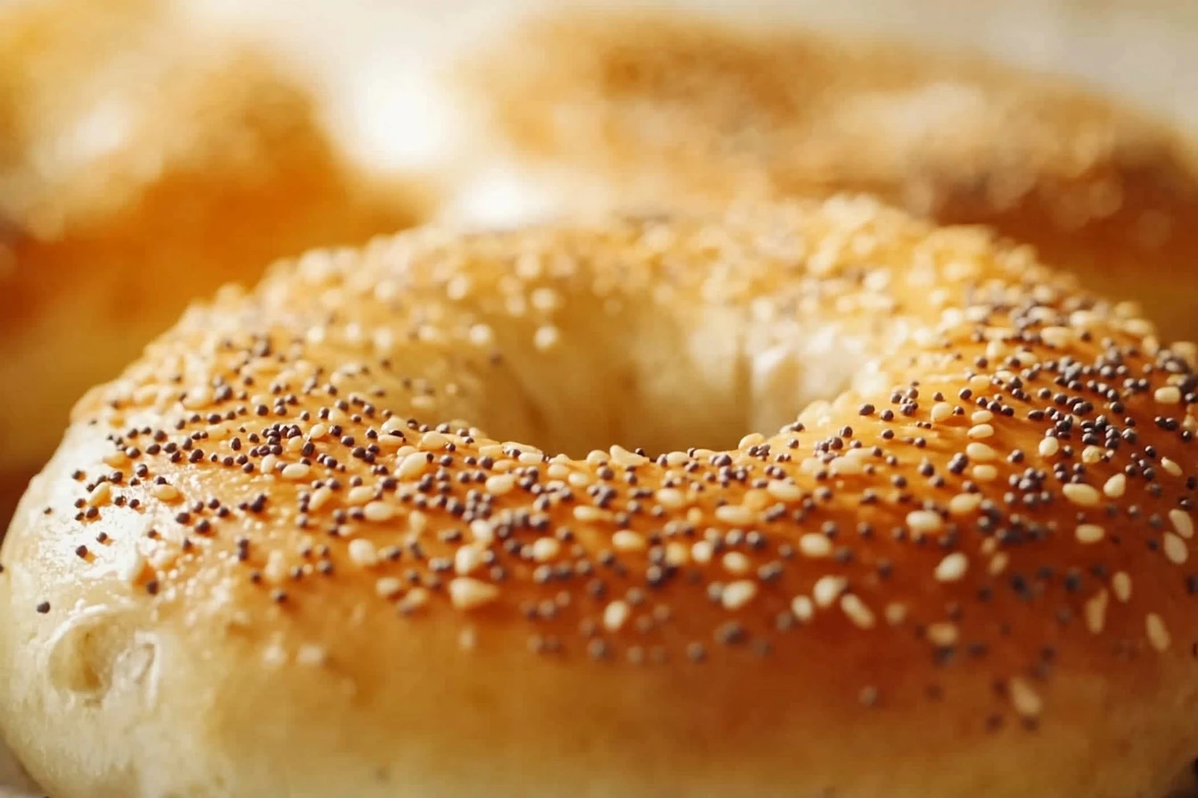 Freshly baked cottage cheese bagels with golden crusts on a cooling rack.